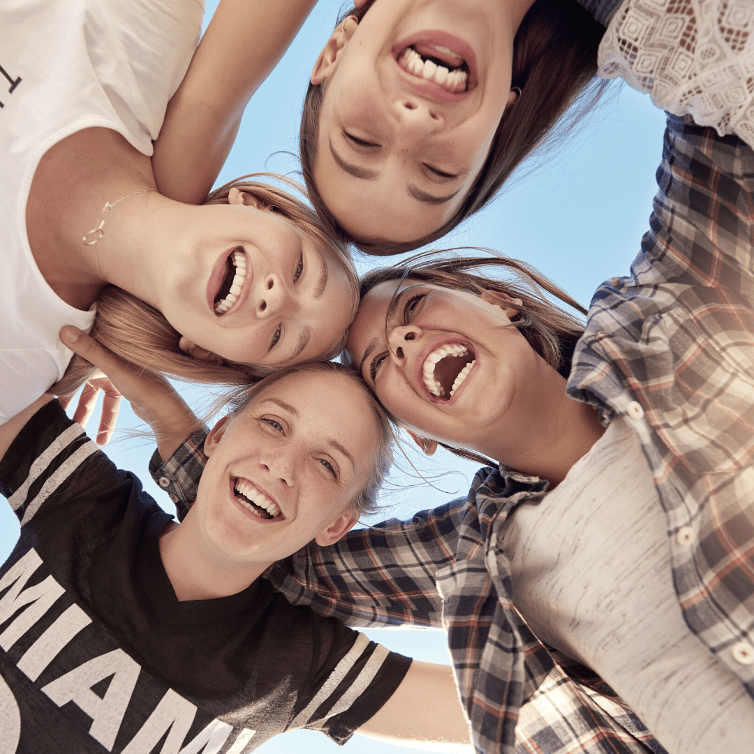Group of smiling friends taking a selfie together