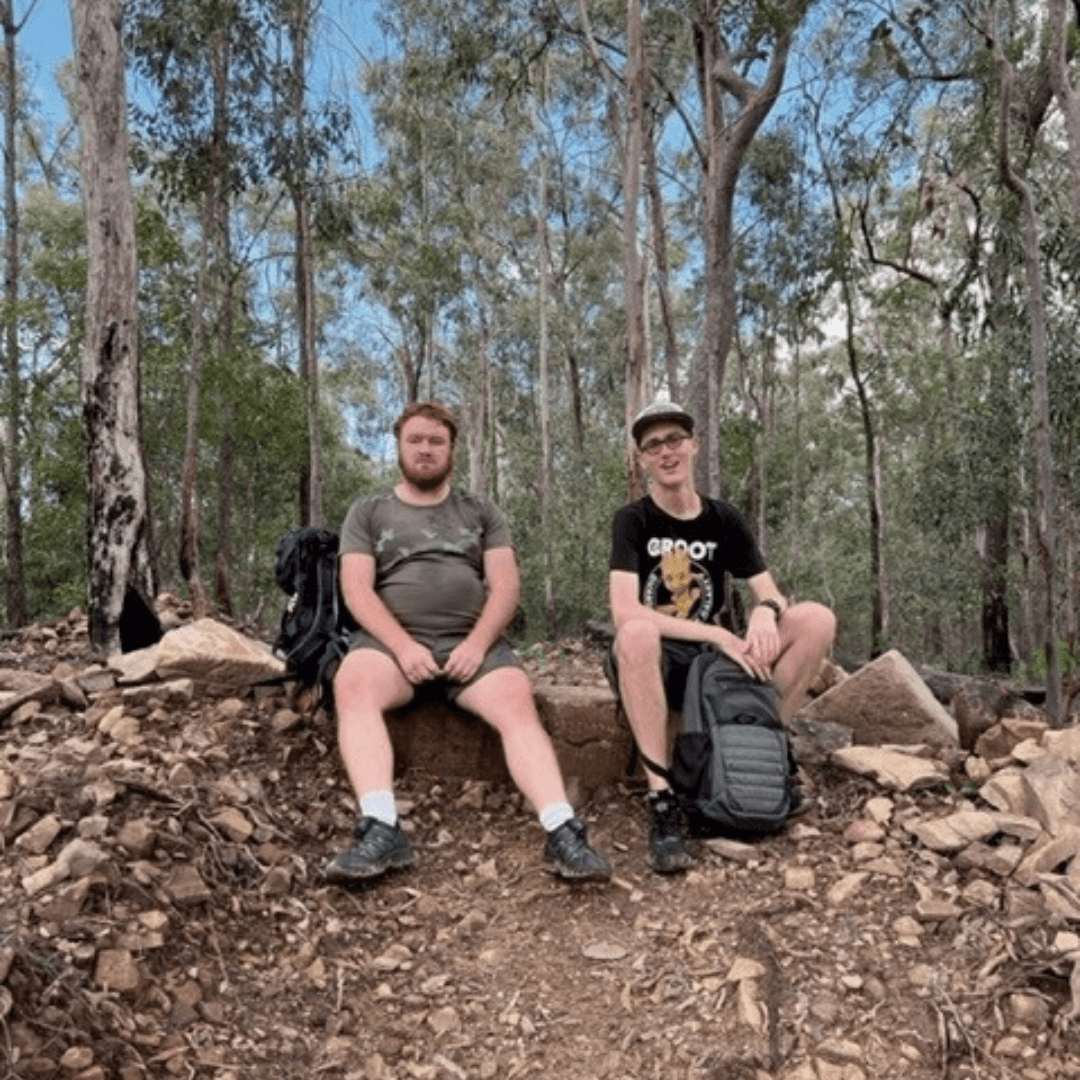 Two participants resting on a bushwalk with the Outdoor Connection Group